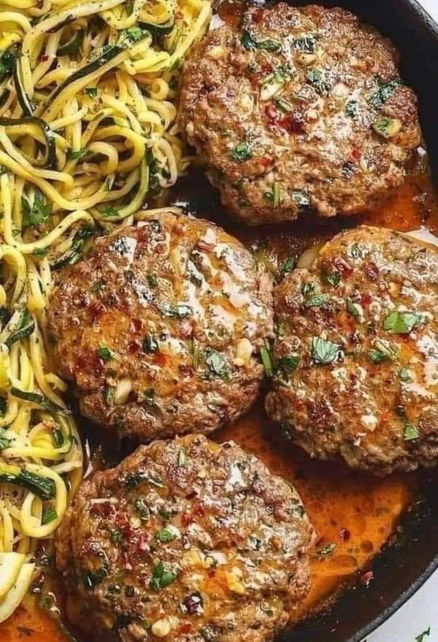 a plate of food with meat patties and noodles